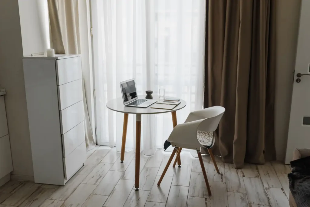 Small home office desk positioned near a window for natural light