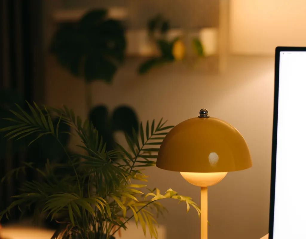Compact desk lamp illuminating a small home office workspace