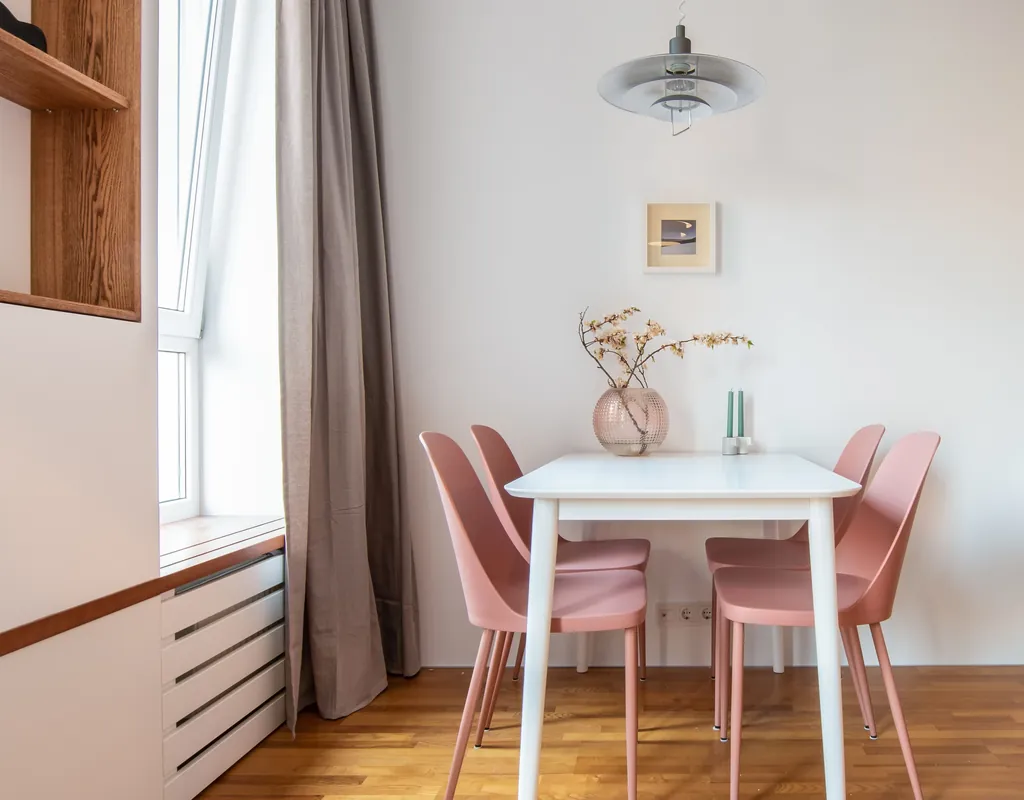 Slim dining chairs around a compact table in a small dining room
