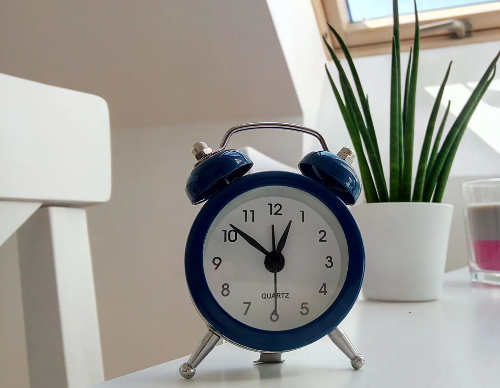 Compact desk clock on a small home office desk