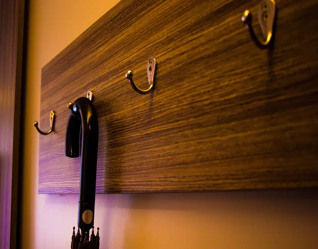 Wall hooks for umbrella coats and bags in a small entryway