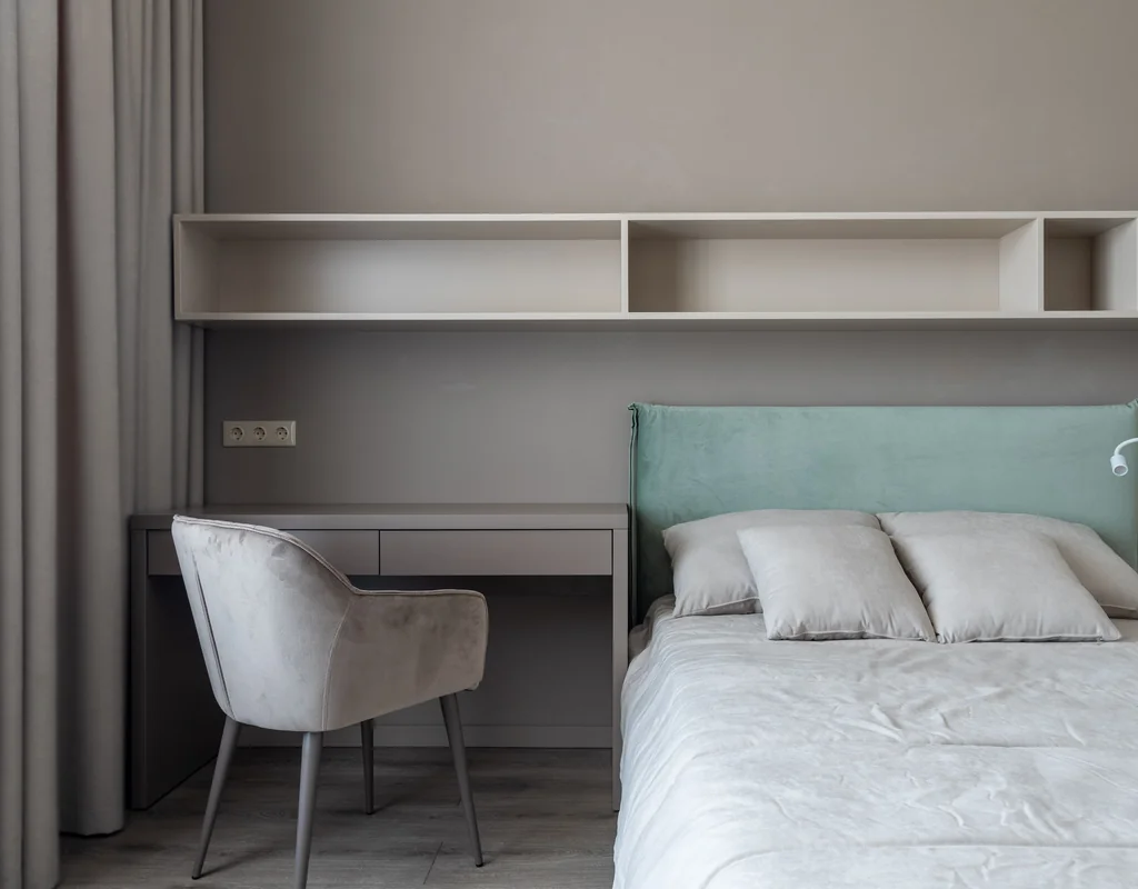 floating shelves above a desk in a small home office