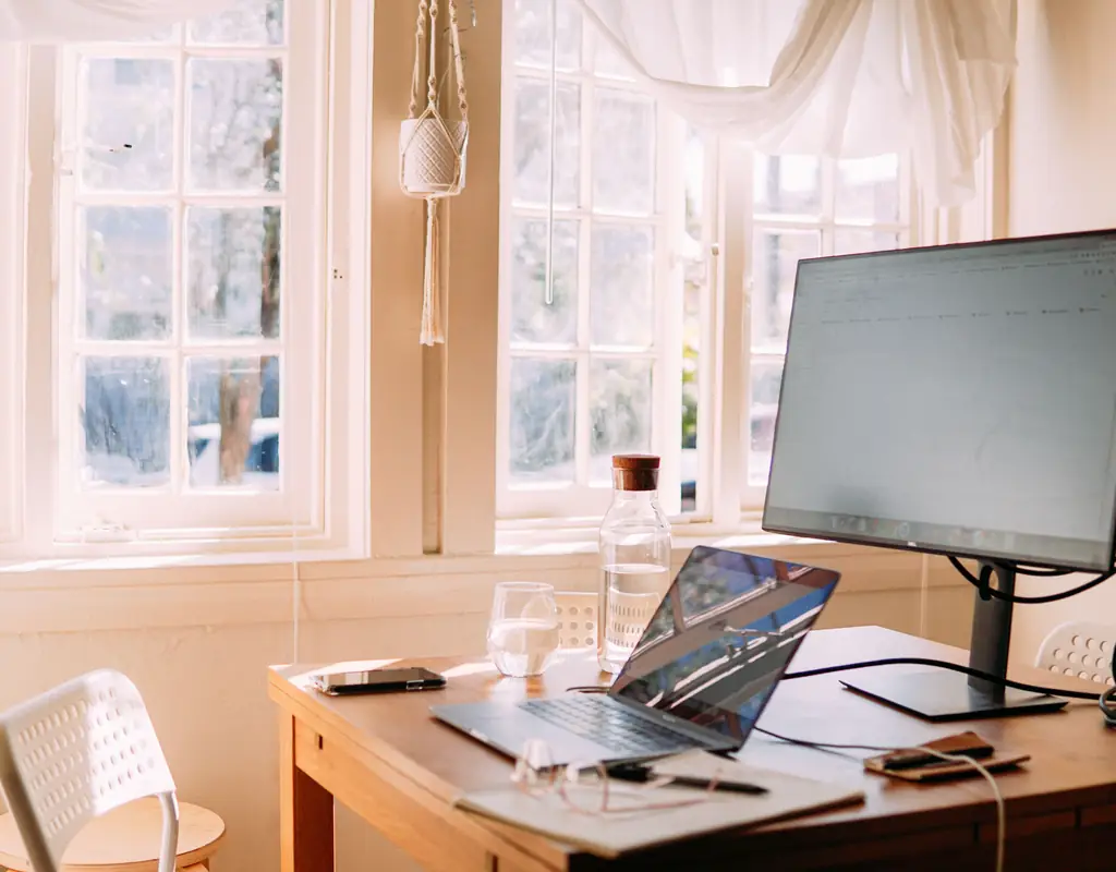 window with curtains for noise reduction in a small home office