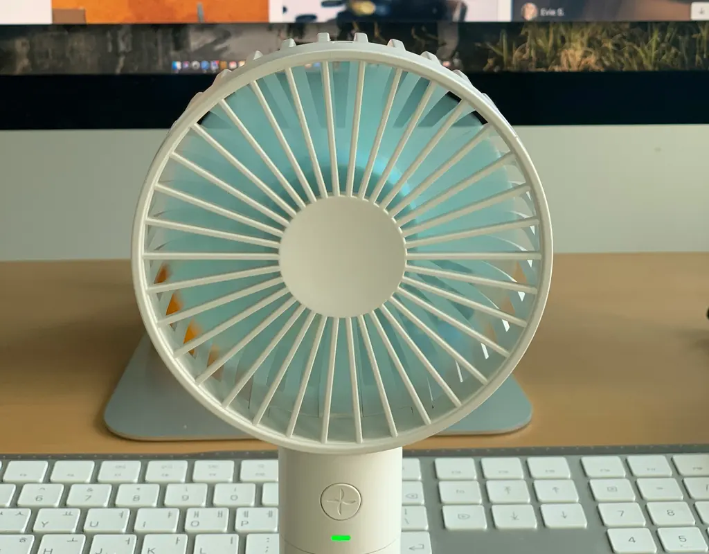 Quiet compact desk fan on a small home office desk