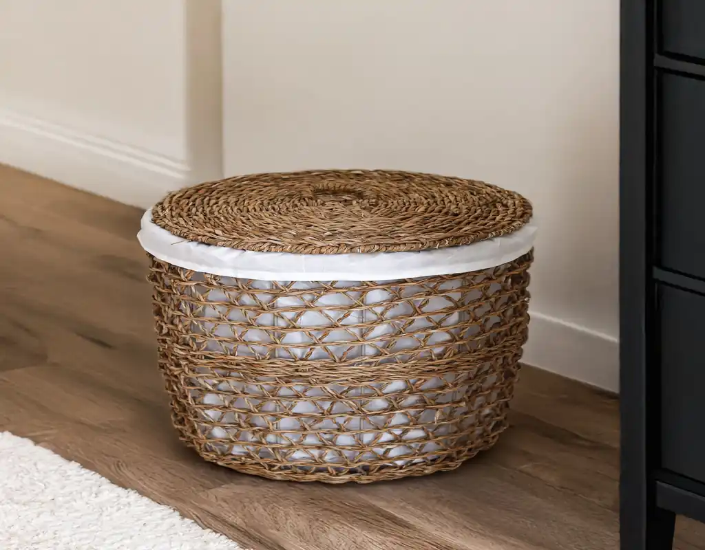 Slim vertical laundry hamper in a small apartment bedroom