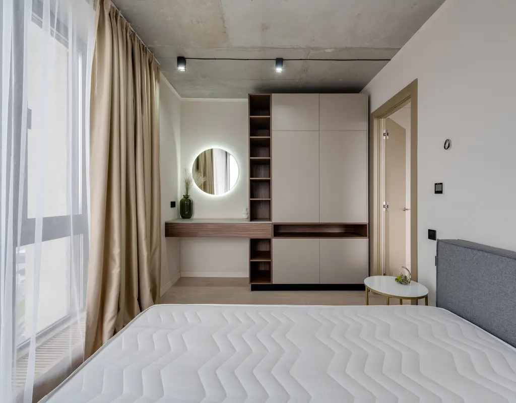 Small bedroom with space-saving furniture and light decor