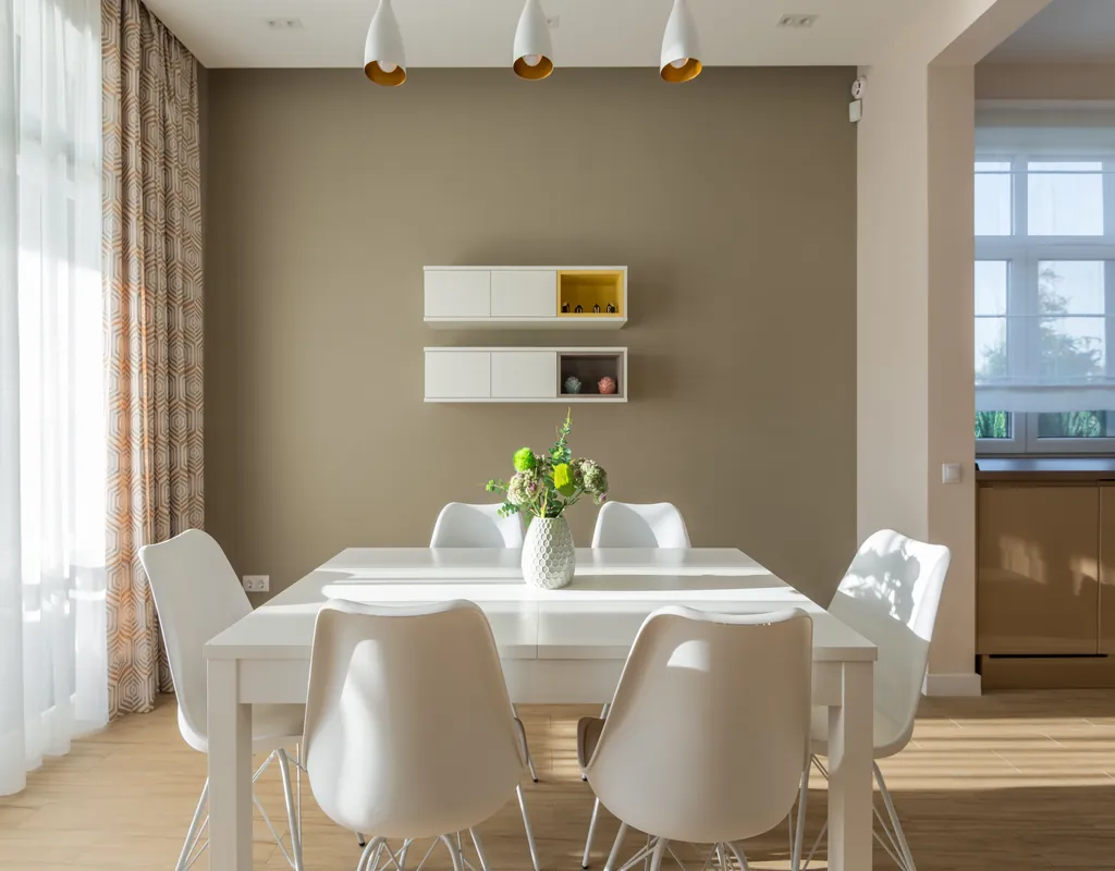 Small dining room with a compact table, chairs, natural light, and simple decor