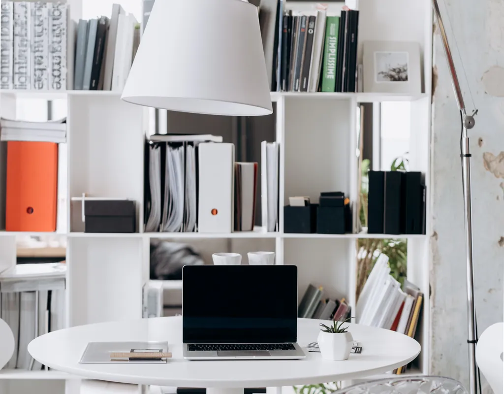 Small home office shelving ideas with shelves arranged above a compact desk
