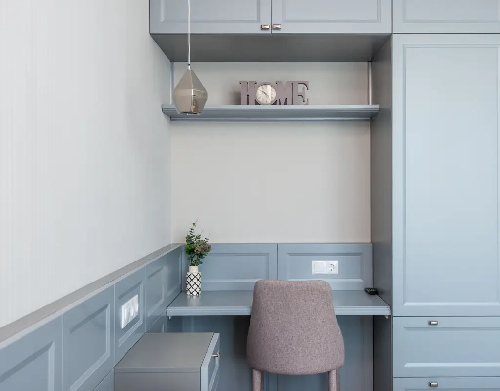 Small home office with a simple desk lamp and ceiling light