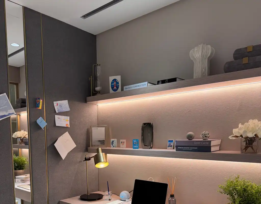 Under-shelf LED lighting illuminating a small home office desk