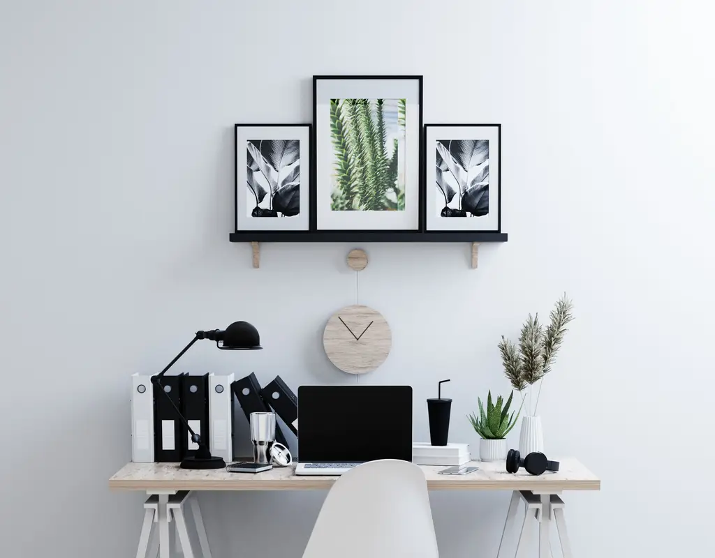 Small home office with simple wall art and personal decor