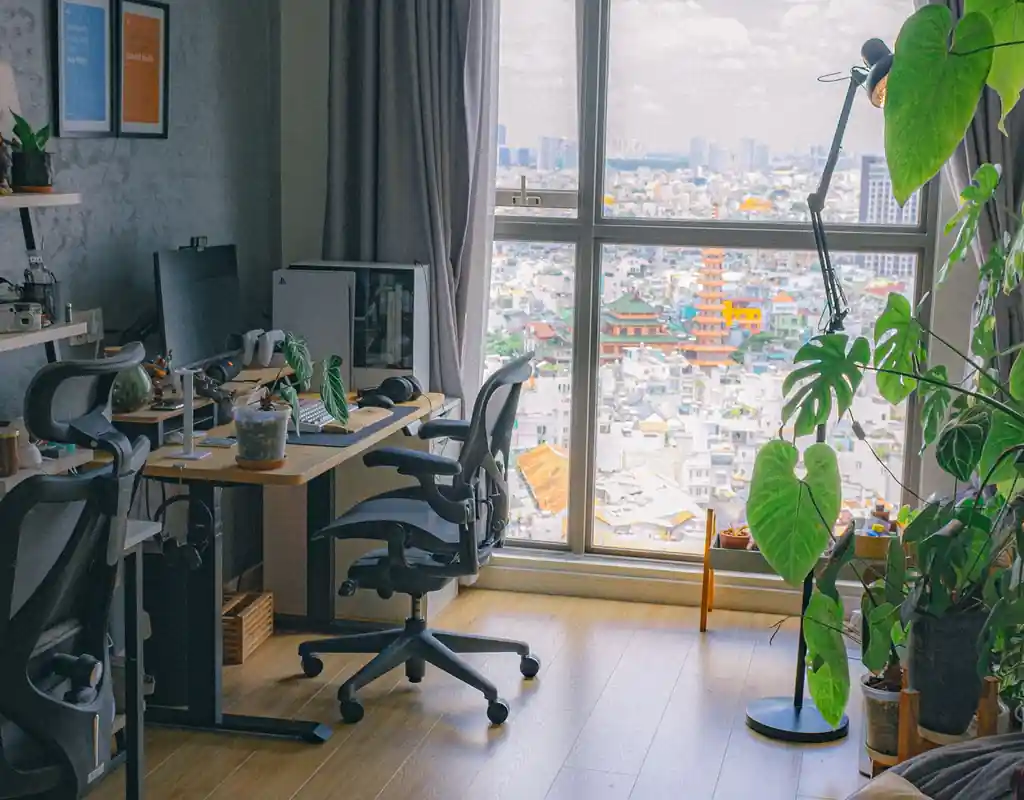 Small home office with a desk positioned near a window and natural light
