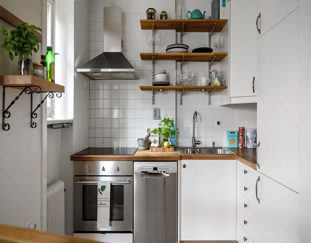 Small kitchen with light colors, organized countertops, and space-saving storage