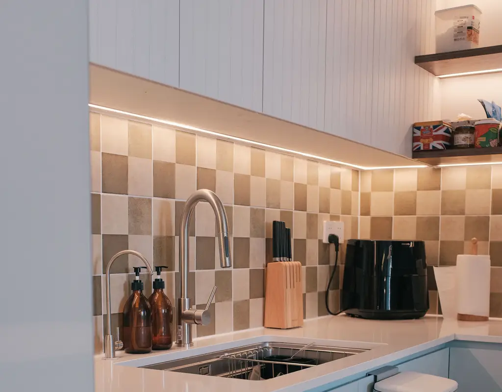 Small kitchen with LED lighting installed under the cabinets