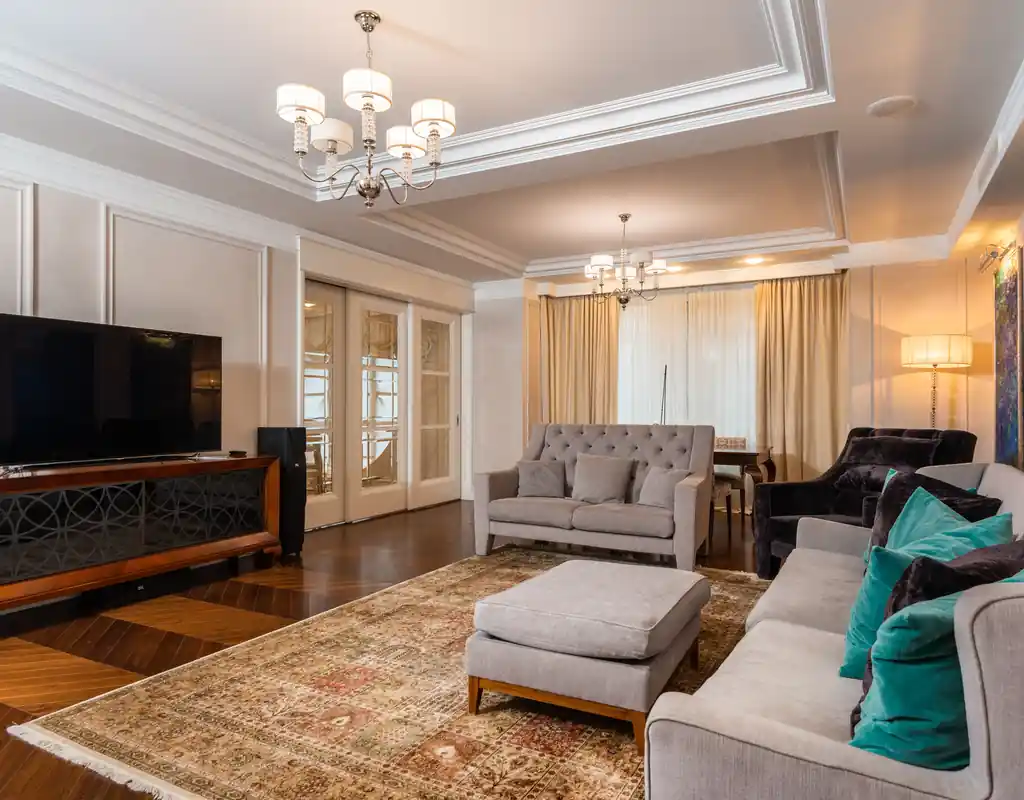 Small living room with ceiling, floor and table lamps providing layered lightingUse Lighting at Different Levels