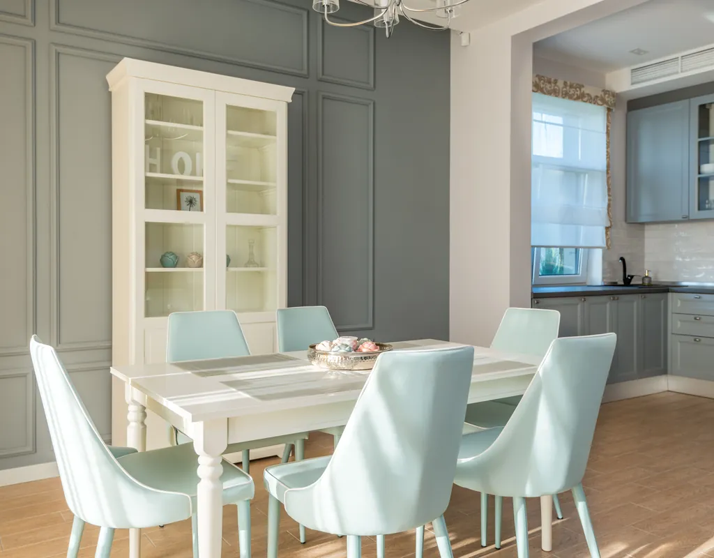 Small dining room with floating shelves displaying dishes, plants, and decor